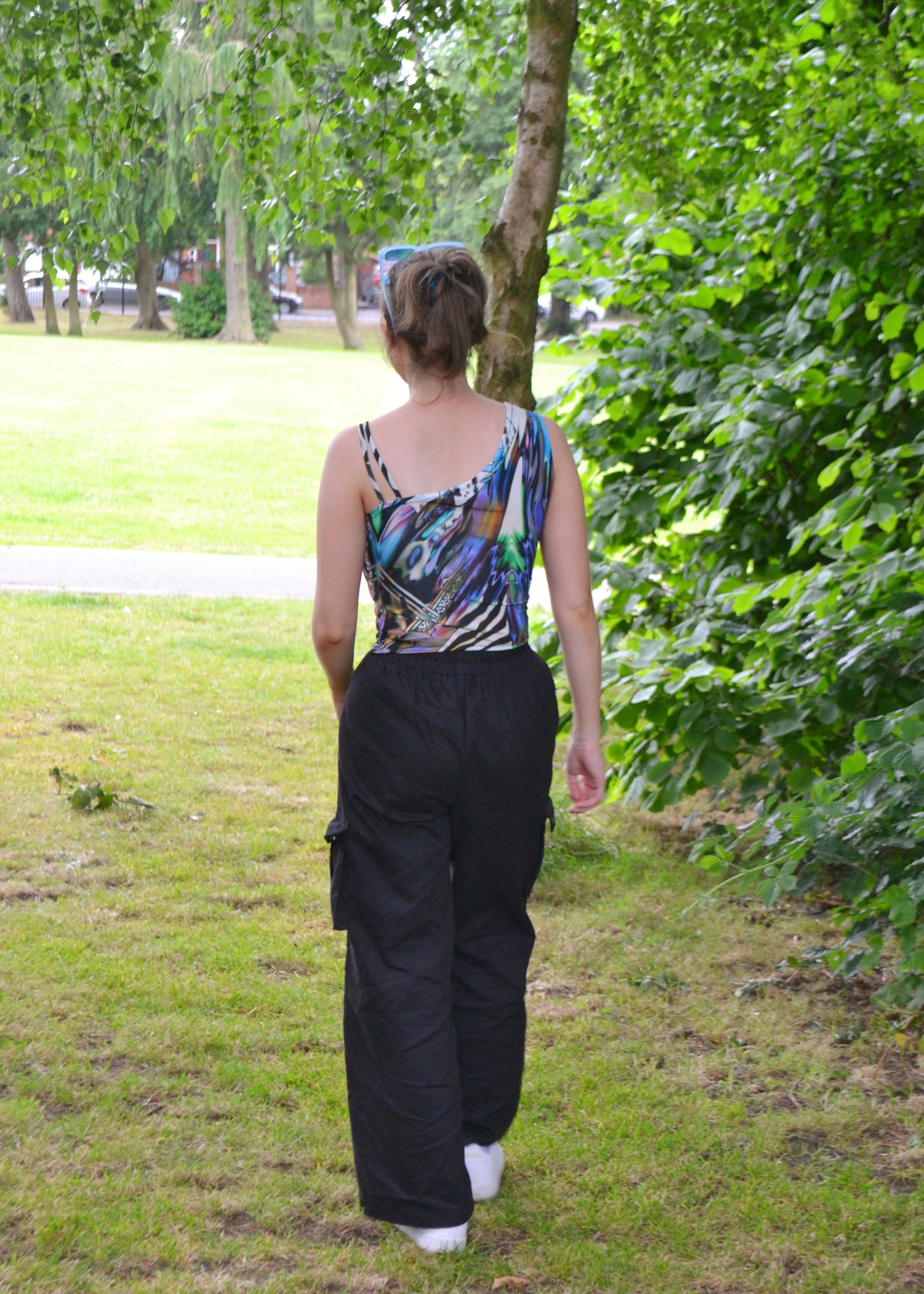 Back view revealing asymmetric cut and strap detail on handmade animal-print top