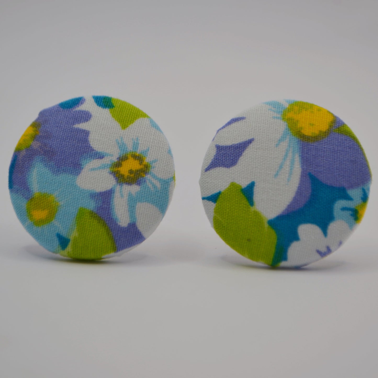 Pair of floral patterned earrings on a white background